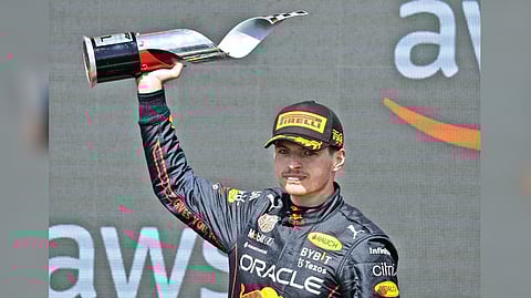 Max Verstappen celebrates his victory on the podium