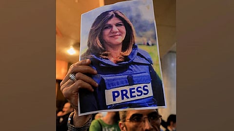 A man holds picture of late Al Jazeera journalist Shireen Abu Akleh