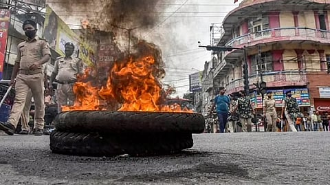 Police personnel patrol amid protests against Centre's 'Agnipath' scheme, in Patna