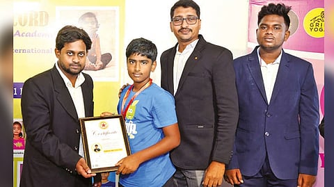 Guneshwar S getting the certificate after creating a record with Noble World Records