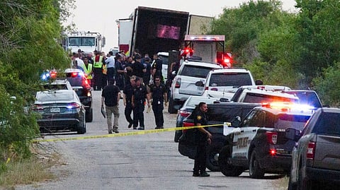 Law enforcement officers work at the scene where people were found dead inside a trailer truck in San Antonio, Texas, U.S.