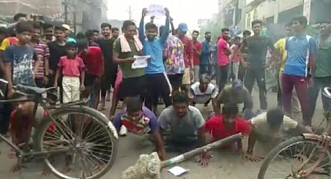 Demonstrators perform push-ups as they protest against "Agnipath scheme" for recruiting personnel for armed forces