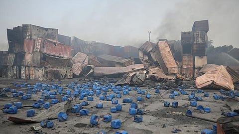 Containers of chemicals lie scattered after explosion