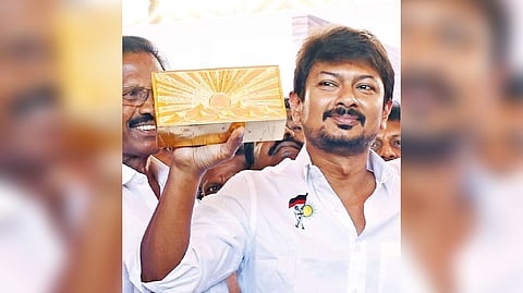 Udhayanidhi Stalin shows the single gold covered brick to be placed for the foundation of party office for Thanjavur north district on Monday