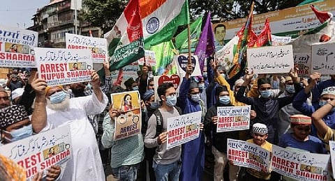People holding placards shout slogans demanding the arrest of Bharatiya Janata Party (BJP) member Nupur Sharma