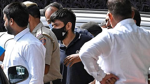 Lawrence Bishnoi (in t-shirt with black face mask)