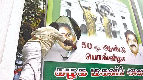 Photos of AIADMK coordinator O Panneerselvam were cut out from the huge hoardings adorning the office and slogans were shouted against him