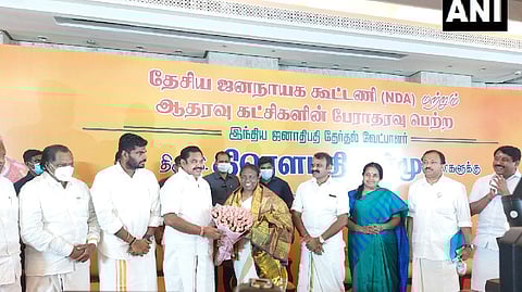 AIADMK leader handing a bouquet to Droupadi Murmu.