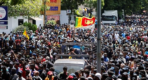 Demonstrators gather outside the office of Sri Lanka's Prime Minister Ranil Wickremesinghe