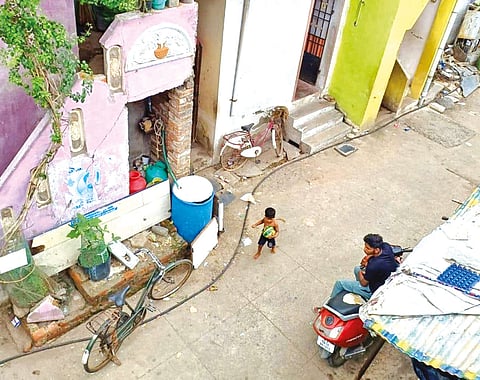 A kid is seen playing near the exposed power cable on sixth street of KM Garden