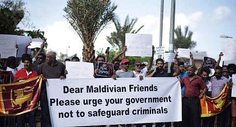 Sri Lankans living in the Maldives stage a demonstration in Male to protest against the arrival of President Gotabaya Rajapaksa