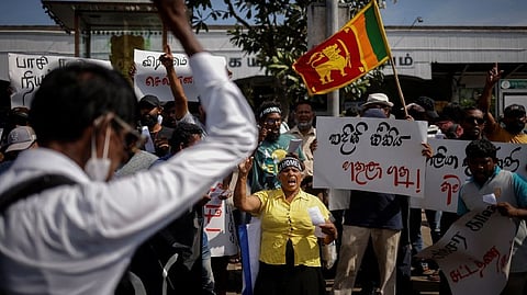 Protestors shout slogans during a protest demanding the resignation of Sri Lanka's acting President Ranil Wickremesinghe