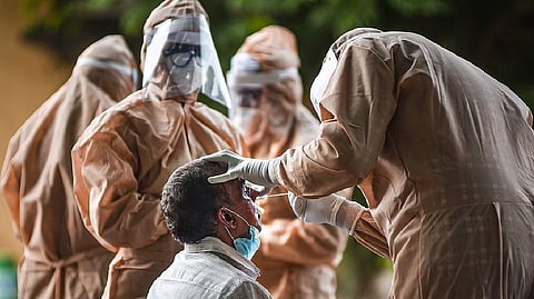 Medics collect a swab sample for Covid-19.