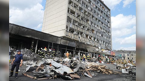 Rescuers at the scene of a building that was damaged by Russian missiles