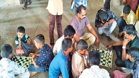 Devotees play chess at the Lord Shiva temple at Thirupoovanur