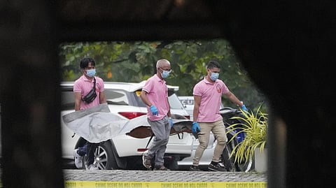 Funeral workers carring a victim's body