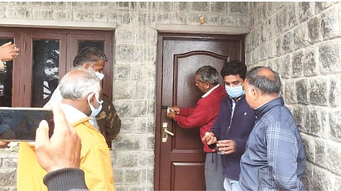Officials sealing the illegally functioning cottage in The Nilgiris on Sunday