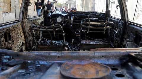 People gather at the scene where two Palestinian militants were killed during clashes with Israeli forces in a raid, in Nablus in the Israeli-occupied West Bank