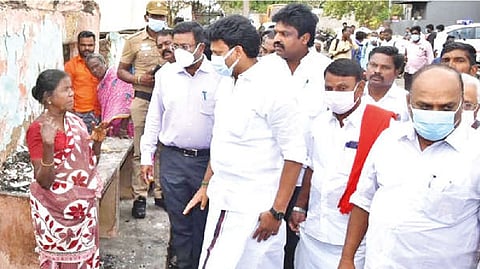 Minister Anbil Mahesh Poyyamozhi inspecting houses ravaged by fire in Thanjavur on Tuesday