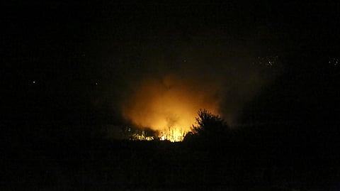 Flames are seen at the site of a plane crash