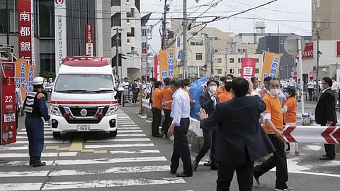 People react after gunshots in Nara, western Japan Friday