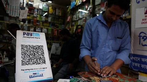 A QR code of Paytm is seen at a mobile repairing shop