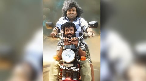 Yogi Babu riding a moped with choreographer Dinesh master seated in front