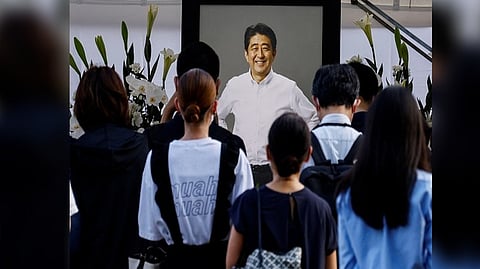 People lay flowers on a flower offering at Abe at Zojoji Temple, where the vigil and funeral of late former Japanese PM Abe, will be held, in Tokyo, Japan.