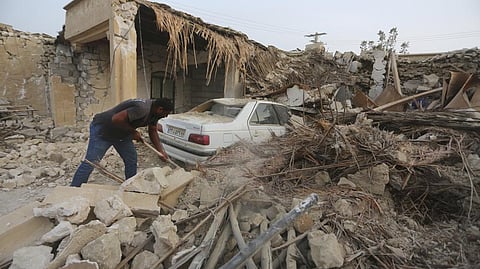 A man cleans up the rubble after an earthquake