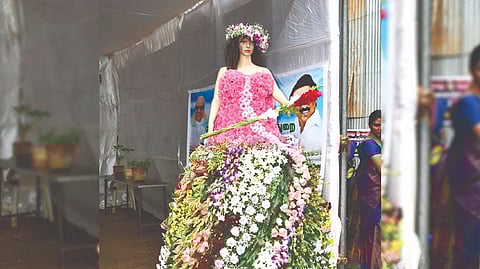 A doll dressed in flowers at the three-day expo in Courtallam