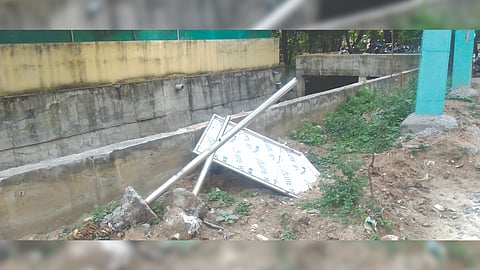 An uprooted street sign after drain work in Vellore.