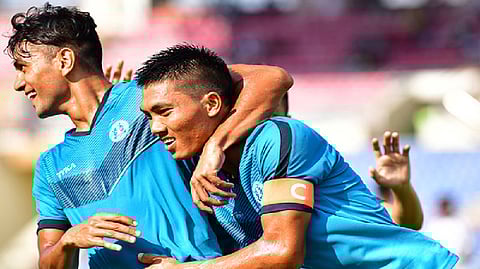Army Green Team players celebrate after scoring a goal