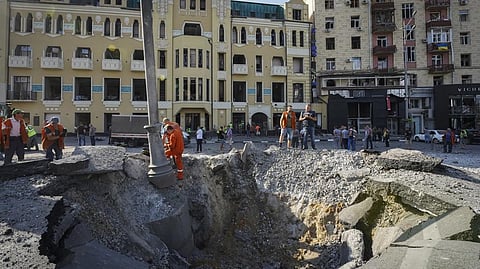 A view of a crater from a night Russian rocket attack, near to damaged buildings in downtown Kharkiv, Ukraine.