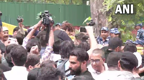 Congress leader Priyanka Gandhi Vadra jumps over a police barricade placed near AICC during party protest against price rise and unemployment in Delhi