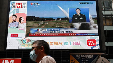 A TV screen shows that China's PLA military exercises, including live firing in the waters and airspace near Taiwan, in Hong Kong, China