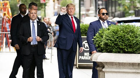 Former President Donald Trump gestures as he departs Trump Tower