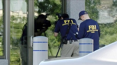 Members of the FBI Evidence Response Team work outside the FBI building in Kenwoo