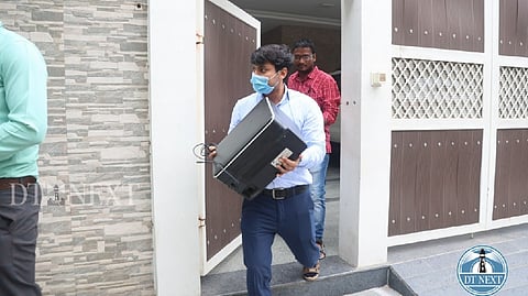 I-T department officials at the Gopuram Cinemas office