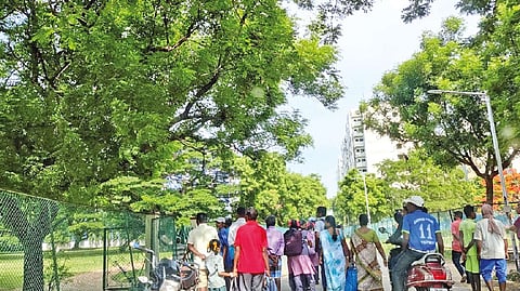 Passersby stopping to watch the Chennai Open