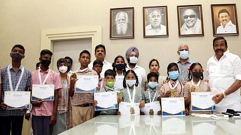 State Municipal Administration Minister KN Nehru handing over certificates to Chennai Corporation school students