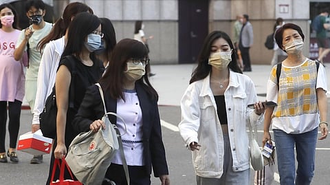 People wear face masks to protect against the spread of the coronavirus in Taipei, Taiwan on Aug. 31, 2022. Taiwan is considering an end to its quarantine requirement for all arrivals in mid-October, the Central Epidemic Command Center said Thursday.