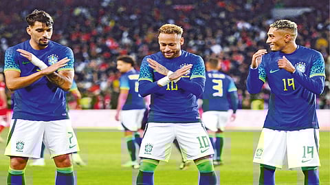 Brazil?s forward Neymar (centre) celebrates with his teammates Lucas Paqueta (left) and Raphinha (right)