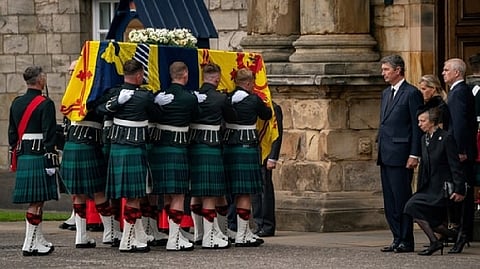 The Princess Royal curtseys the coffin of Queen Elizabeth II, draped with the Royal Standard of Scotland, as it arrives at Holyroodhouse.