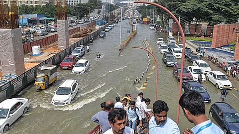Vehicles pass through the waterlogged Outer Ring Road after heavy monsoon rains, near Bellandur in Bengaluru.