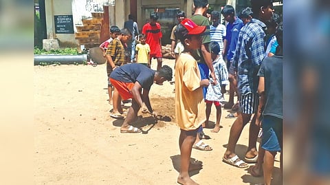 Youngsters filling up the pit dug for bhoomi pooja.