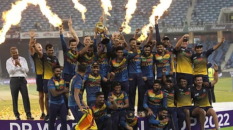 Sri Lankan players celebrate with the winners trophy after their win in the T20 cricket Asia Cup final match against Pakistan, in Dubai, United Arab Emirates