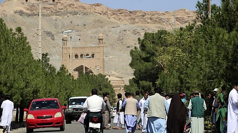 Afghan people gather near the site of an explosion