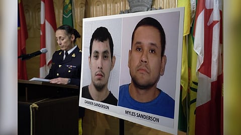 Assistant Commissioner Rhonda Blackmore speaks next to images of Damien Sanderson and Myles Sanderson during a press conference