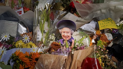 A small cutout of the late British Queen Elizabeth is displayed among other tributes at Green Park
