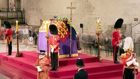 A long exposure photograph showing members of the public as they file past the coffin of Queen Elizabeth II